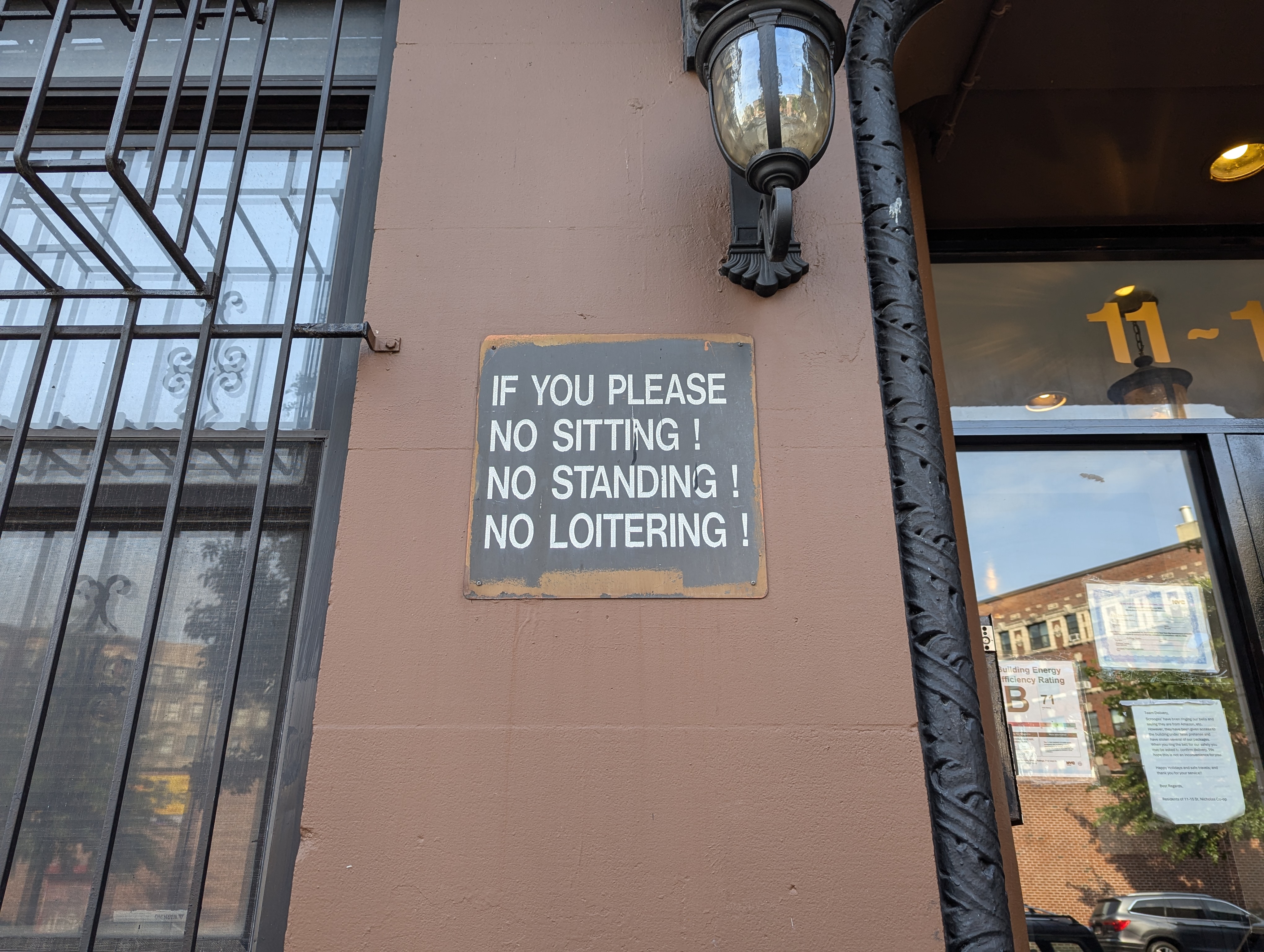 Building with a sign in Harlem, with reasons you could get a summons.